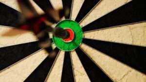 Worte und Taten sind synchron miteinander. Das Bild zeigt eine Dartscheibe mit einem Pfeil in der 100
